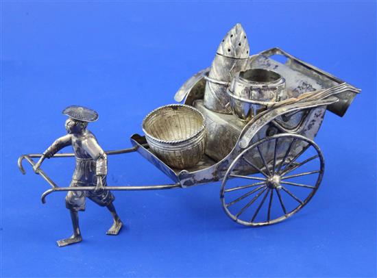 A late 19th/early 20th century Chinese Export silver novelty cruet stand, modelled as a Chinaman pulling a rickshaw,